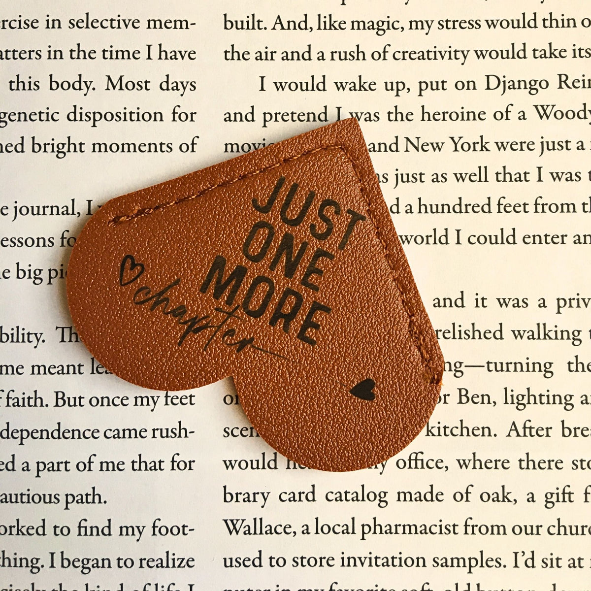 Leather heart bookmark from Heartfelt Gifts with "Just One More Chapter" inscription, perfect for book lovers.