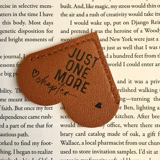 Leather heart bookmark from Heartfelt Gifts with "Just One More Chapter" inscription, perfect for book lovers.