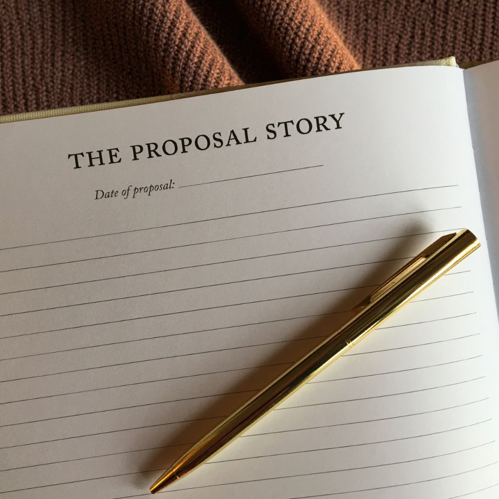 Heartfelt Gifts engagement journal resting on a chocolate brown blanket, ready for writing proposal stories and special memories.