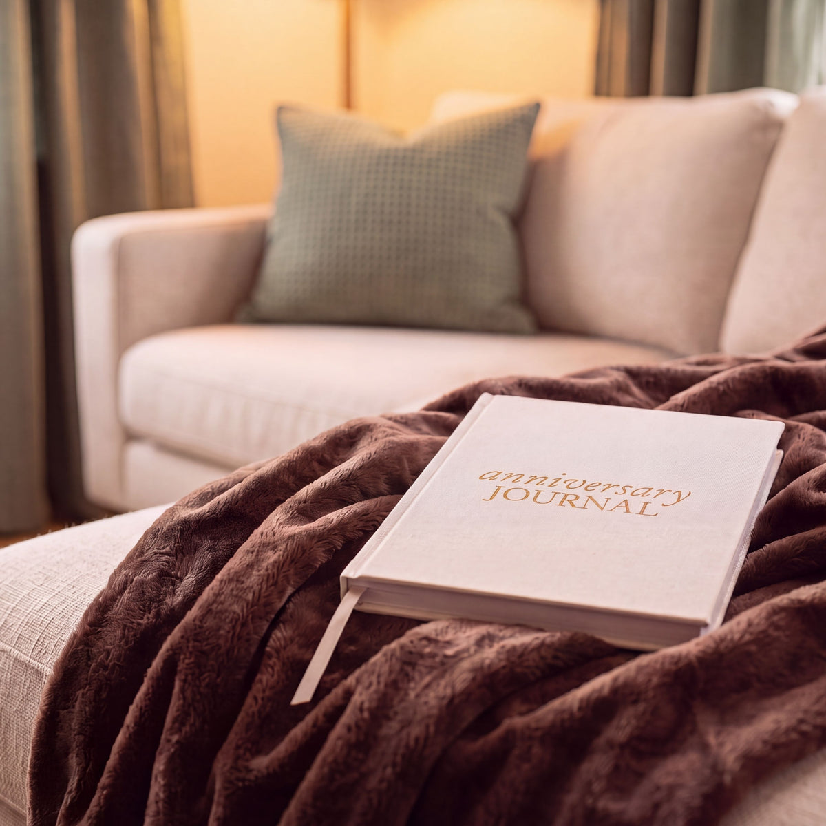 Heartfelt Gifts anniversary journal with a decorative cover, displayed on a sofa for cozy, personal note-taking or celebration.